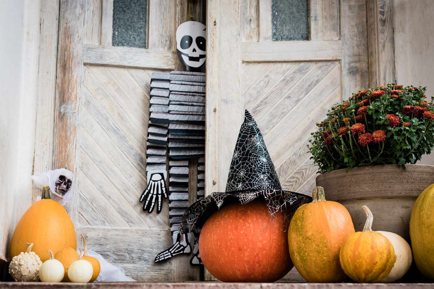 Fun World Shop -Fun World Shop halloween decorated front door with various size and shape pumpkins and skeletons front porch decorated for the halloween season 1042539328 88cd53b25bd54457afc89f755cdf995f